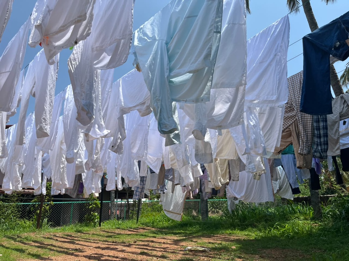 Freshly laundered whites drying in the Mangalore sun at Coronet Cleaners