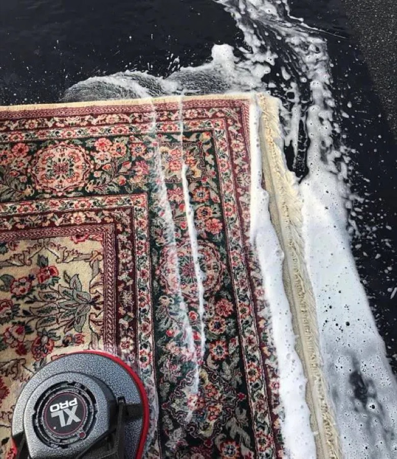 A patterned rug being deep-cleaned with foam