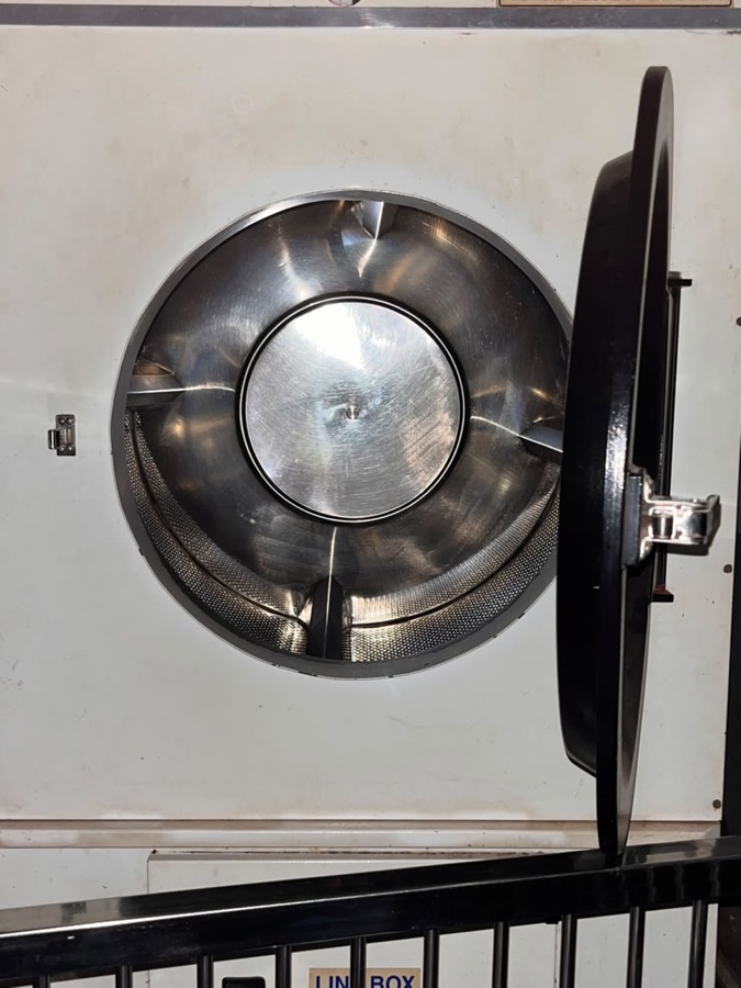 Open drum of a large-capacity cleaning machine at Coronet Cleaners