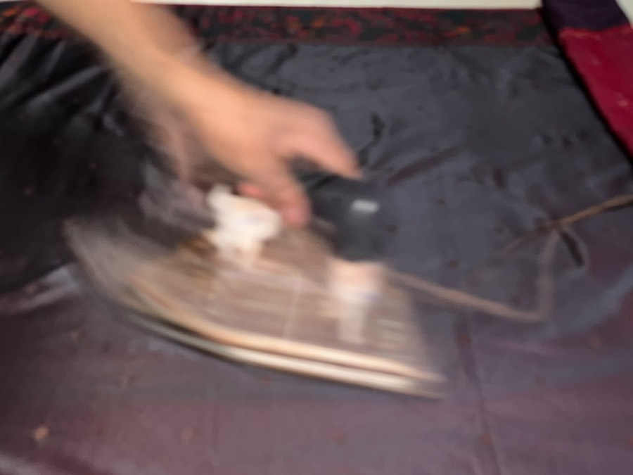 A garment being hand-pressed at Coronet Cleaners