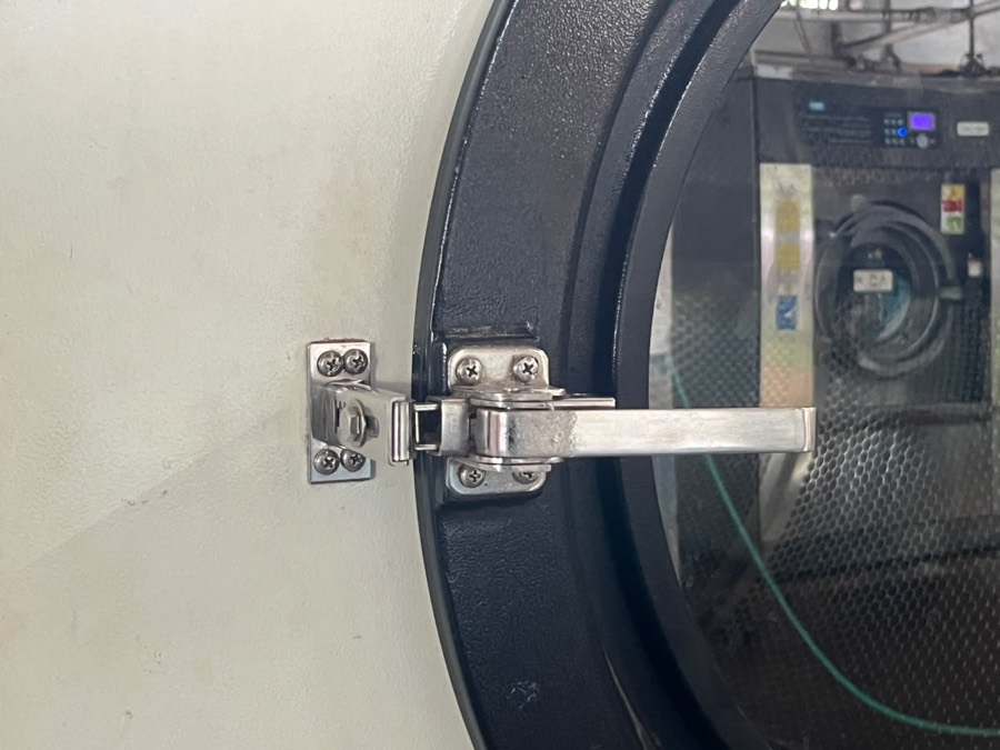 Porthole door of a washing machine at Coronet Cleaners
